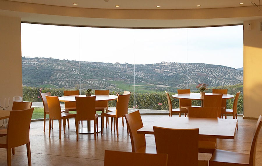 wine tasting room with wood tables and chairs at Boutari Crete Winery
